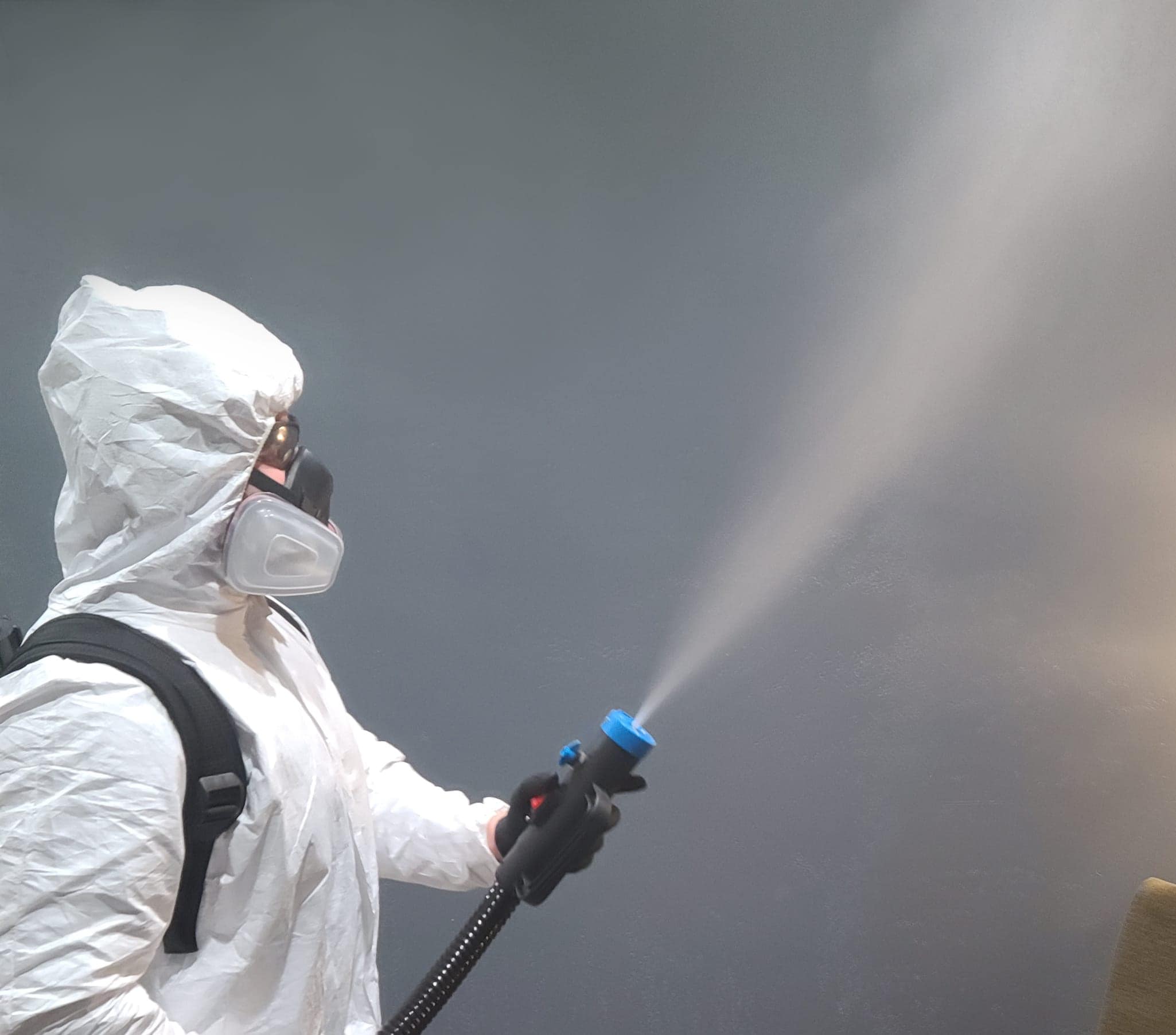 Sanitization tech cleaning a room.