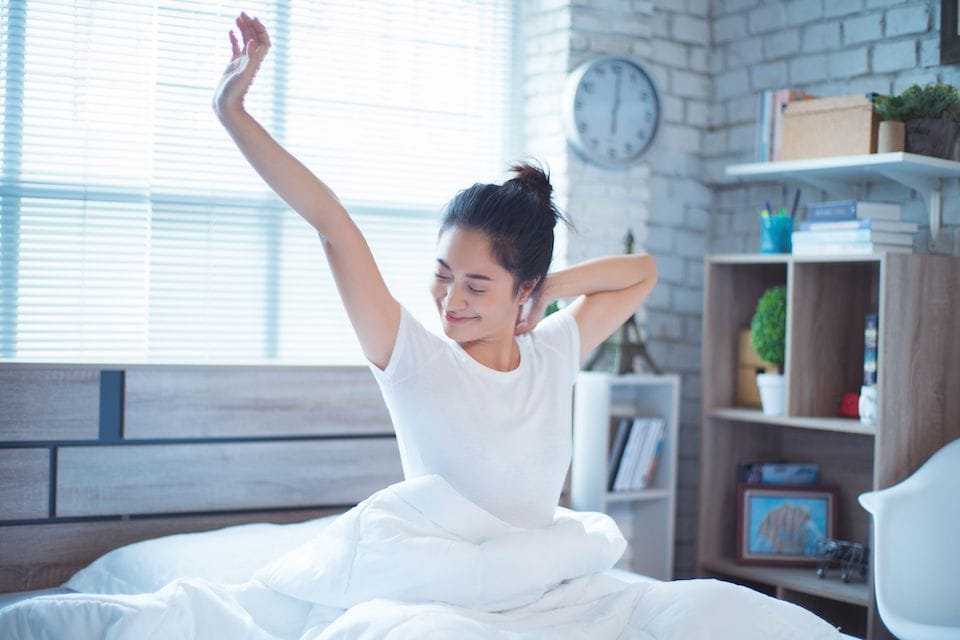 Image of someone getting up from a good nights sleep. Your HVAC System Can Enhance Sleep.